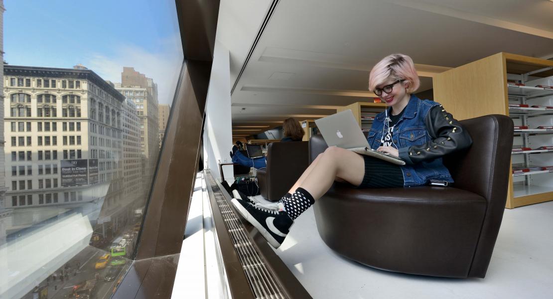 Photo of student on laptop in Library